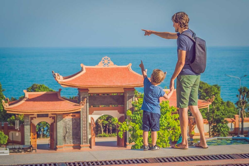 Father and son visiting Ho Quoc Pagoda in Phu Quoc during a family holiday in Vietnam
