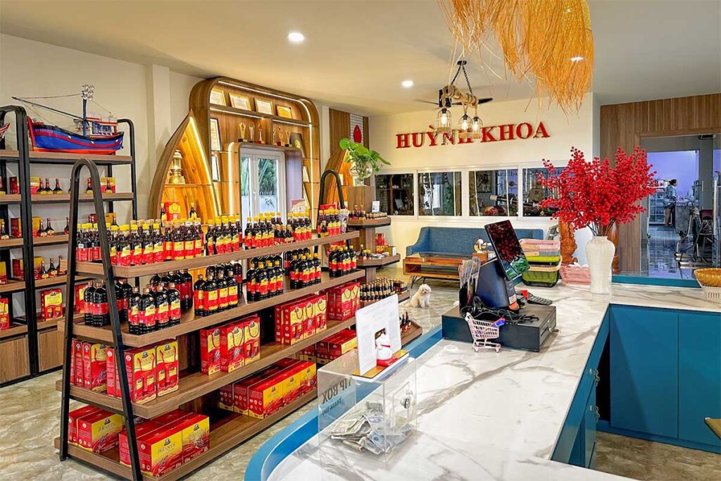 Fish sauce products and souvenir bottles displayed inside a traditional fish sauce factory shop in Phu Quoc
