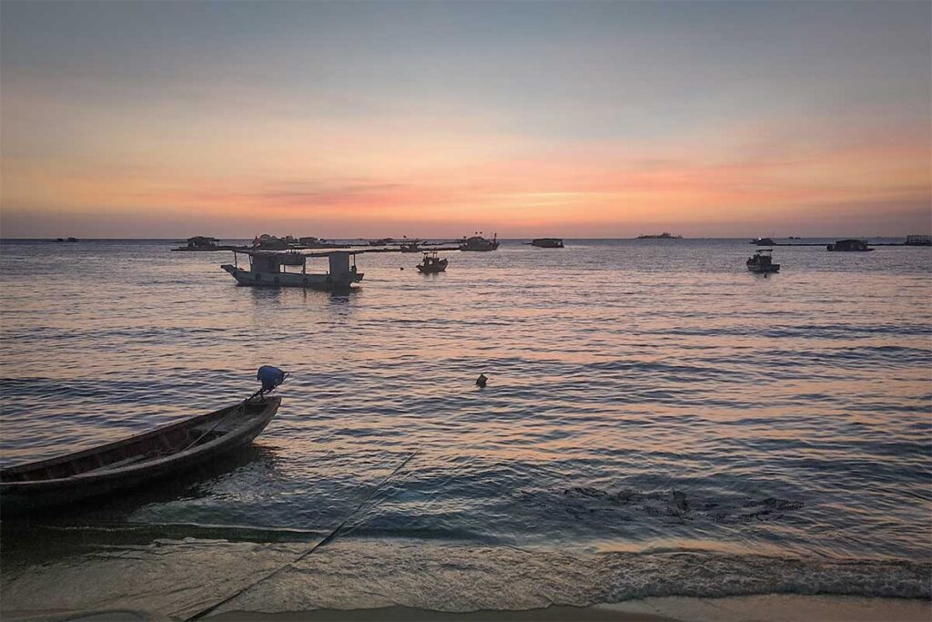 Fishing boats near Ganh Dau Cape in Phu Quoc during sunset with calm sea water and soft evening colors