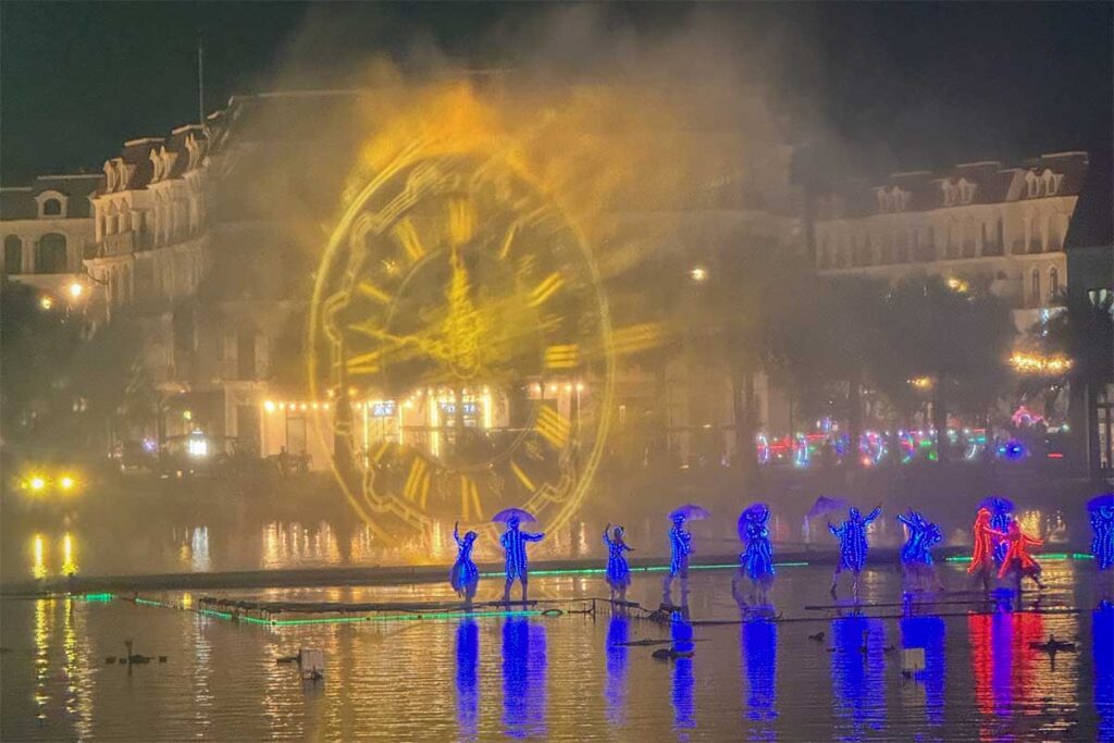Evening laser and water show at Grand World Phu Quoc with performers on the lake and colorful lights