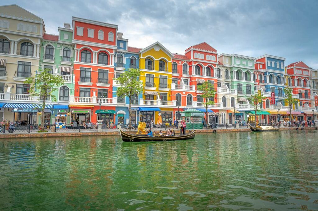 Gondola boat ride on the Venice River at Grand World Phu Quoc with colorful buildings along the canal