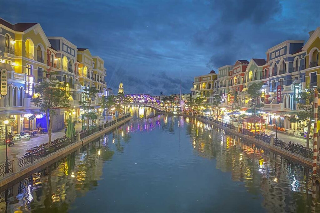 Evening atmosphere along the Venice River canal at Grand World Phu Quoc with colorful lights reflected on the water