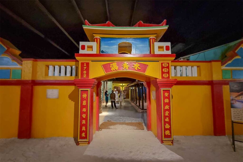 The Ham Ho ancestral house reconstruction inside Lang Chai Xua Fish Sauce Museum, showing a traditional Vietnamese gate with yellow and red architecture dating to 1762
