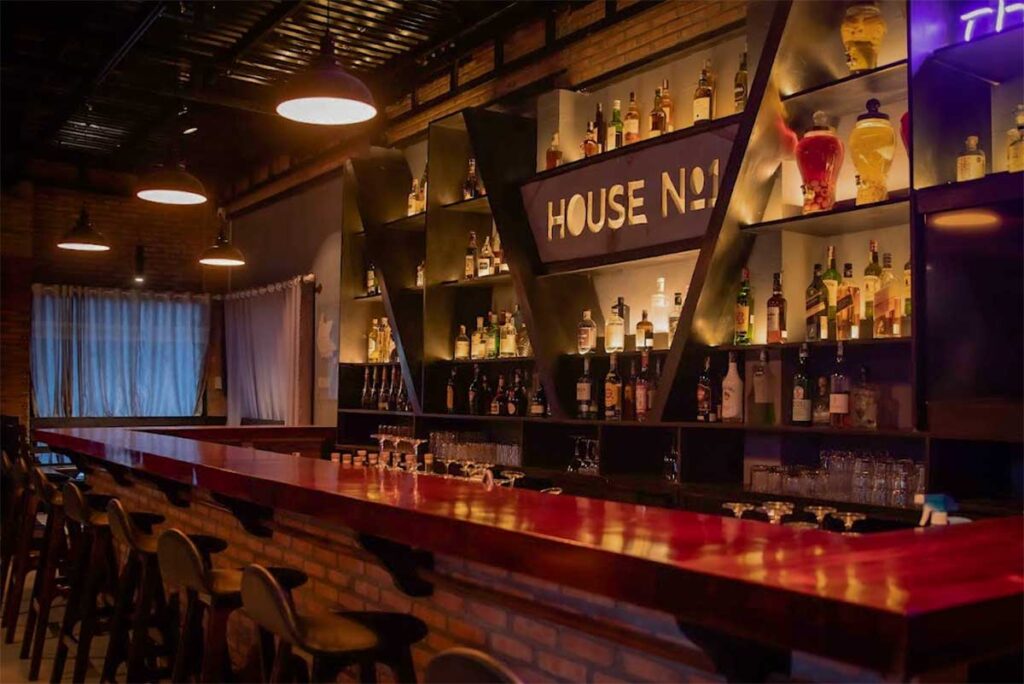 House No 1 cocktail bar in Phu Quoc with modern bar interior, whisky bottles, and lively nightlife atmosphere near Duong Dong