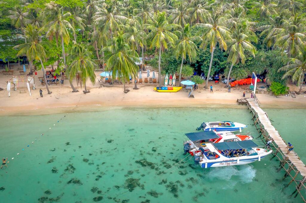 Aerial view of speedboats docked at a tropical island during an island hopping tour in Phu Quoc