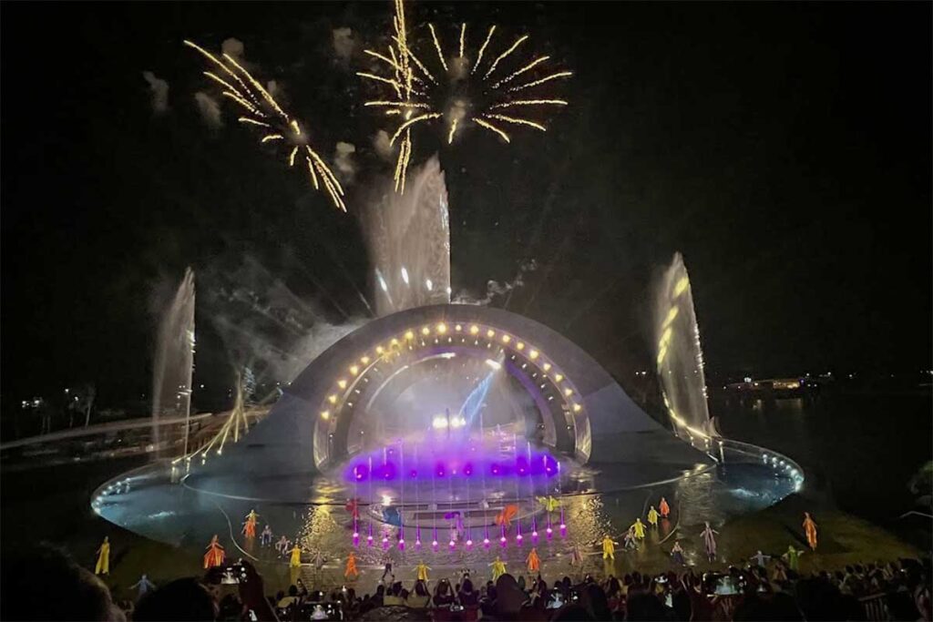 Kiss of the Sea Phu Quoc stage with dancers water fountains and fireworks lighting up the night sky in Sunset Town