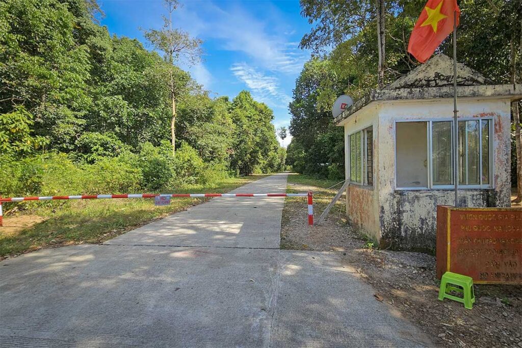 Closed barrier at a restricted entrance to Phu Quoc National Park with a no entry sign and a guard post, showing why independent access to the park is difficult