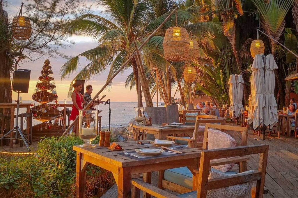 Beachfront restaurant in Ong Lang Beach Phu Quoc with sunset views, live music, and romantic seaside dining atmosphere at night