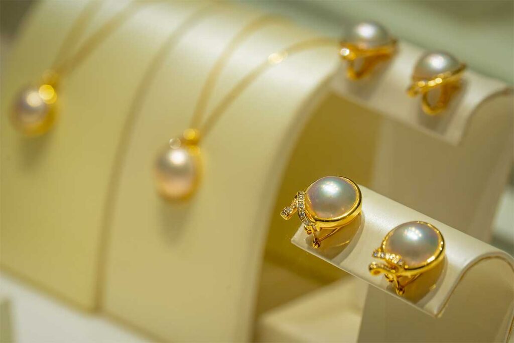 Luxury pearl earrings and jewelry displayed in a pearl showroom in Phu Quoc with elegant gold settings and white pearls