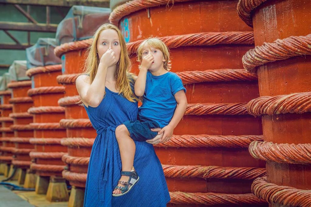 Mother and child visiting a traditional fish sauce factory in Phu Quoc during a family holiday
