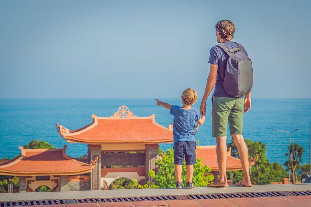 Father and child enjoying sea views at Ho Quoc Pagoda during a family trip in Phu Quoc