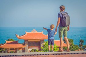 Father and child enjoying sea views at Ho Quoc Pagoda during a family trip in Phu Quoc