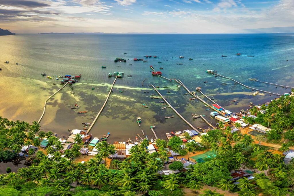 Aerial view of Rach Vem Fishing Village in Phu Quoc with floating seafood restaurants and long wooden piers over the sea