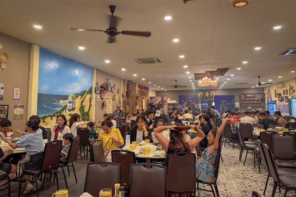 Busy restaurant inside the Lang Chai Xua complex in Phan Thiet, with local Vietnamese decor and a full dining room of guests