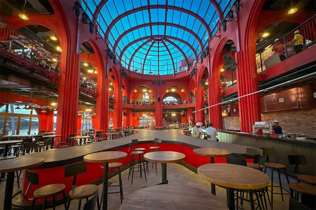 Restaurant interior in Sunset Town Phu Quoc with large red hall design high ceiling and modern dining space