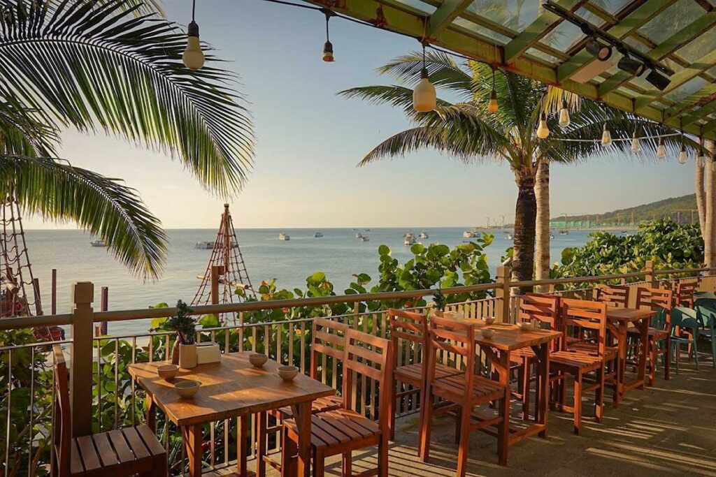 Seafront restaurant in Sunset Town Phu Quoc with ocean view palm trees and outdoor dining terrace