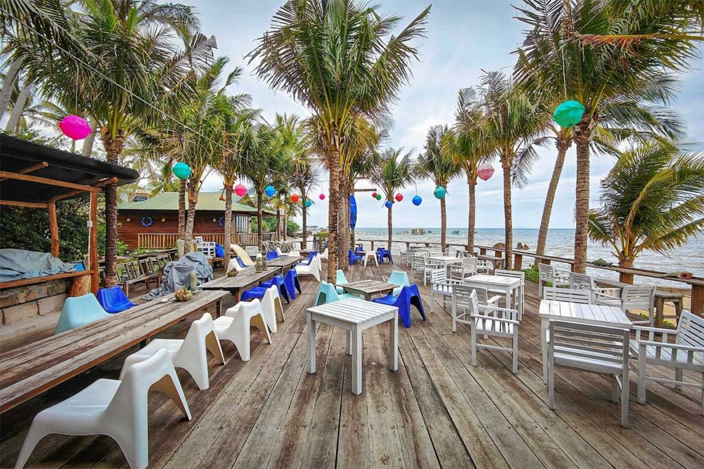 Rorys Beach Bar in Phu Quoc with beachfront seating, tropical palm trees, and relaxed seaside atmosphere on the east coast