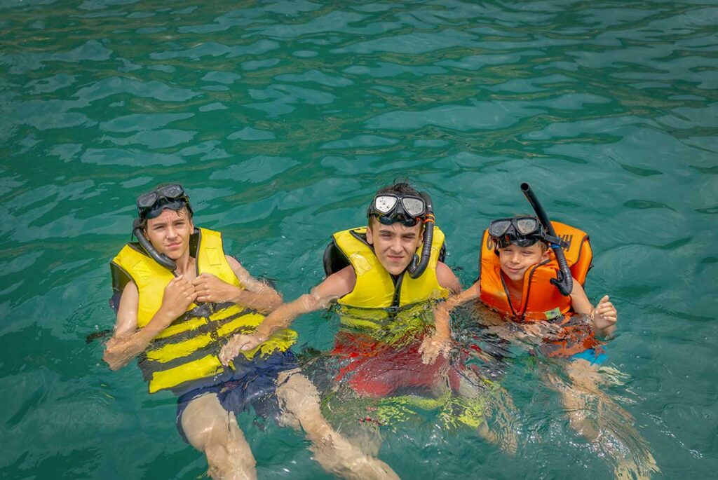 Children snorkeling during an island hopping boat tour in Phu Quoc Vietnam
