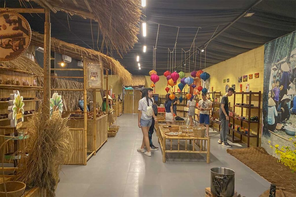 Indoor market area at Lang Chai Xua Fish Sauce Museum with bamboo stalls, lanterns and local products for sale