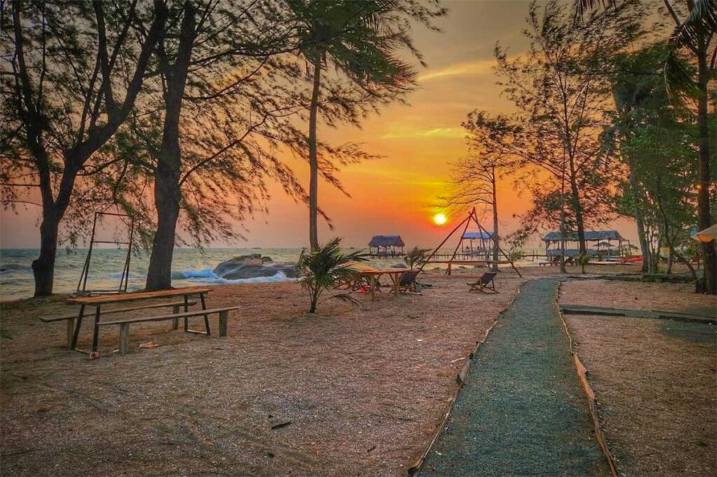 Quiet sunrise at Bai Thom Beach in Phu Quoc with trees wooden swings and a peaceful coastal atmosphere