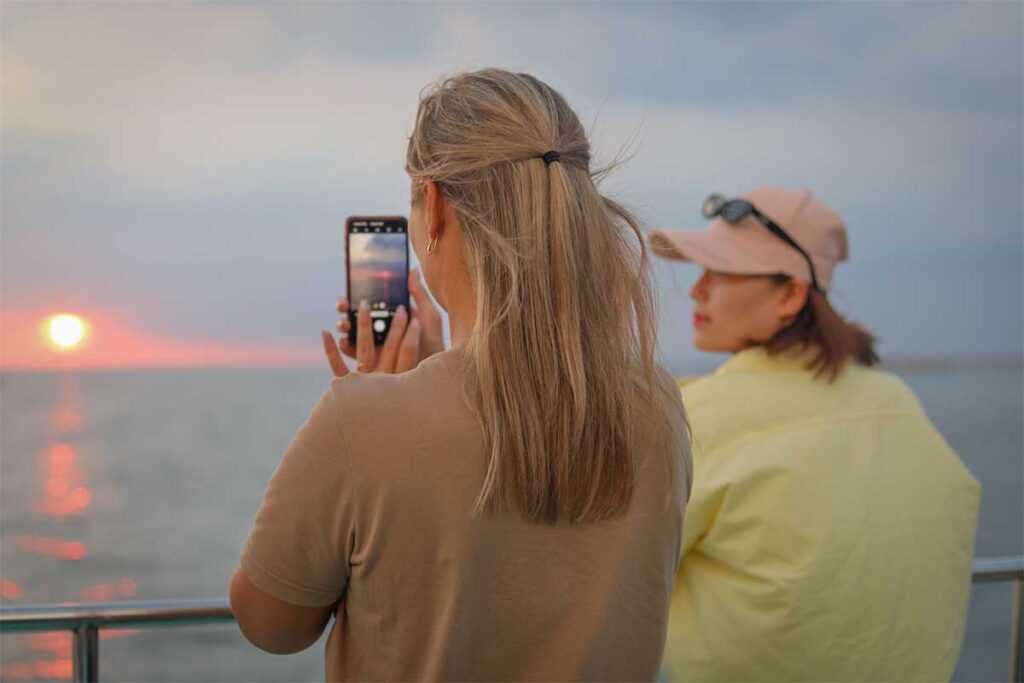 Travelers watching the sunset during a boat tour in Phu Quoc with ocean views and evening atmosphere on the sea