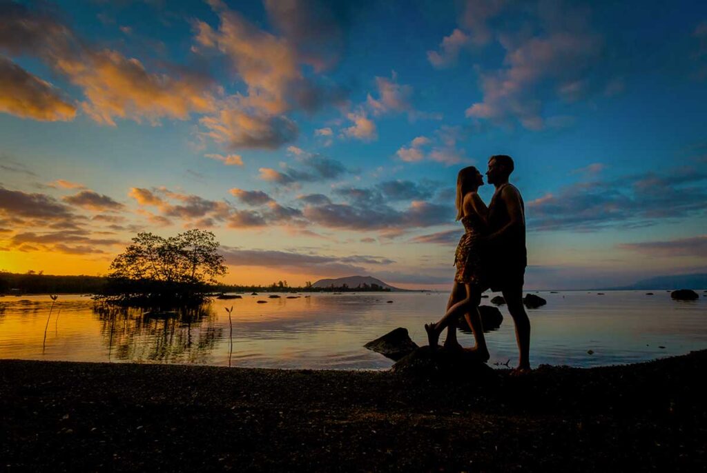 Romantic silhouette of a couple walking on the beach during sunset in Phu Quoc Vietnam