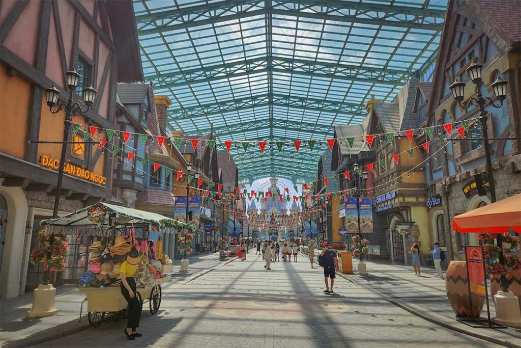 European themed shopping street at VinWonders Phu Quoc with souvenir shops restaurants and covered walking area inside the theme park