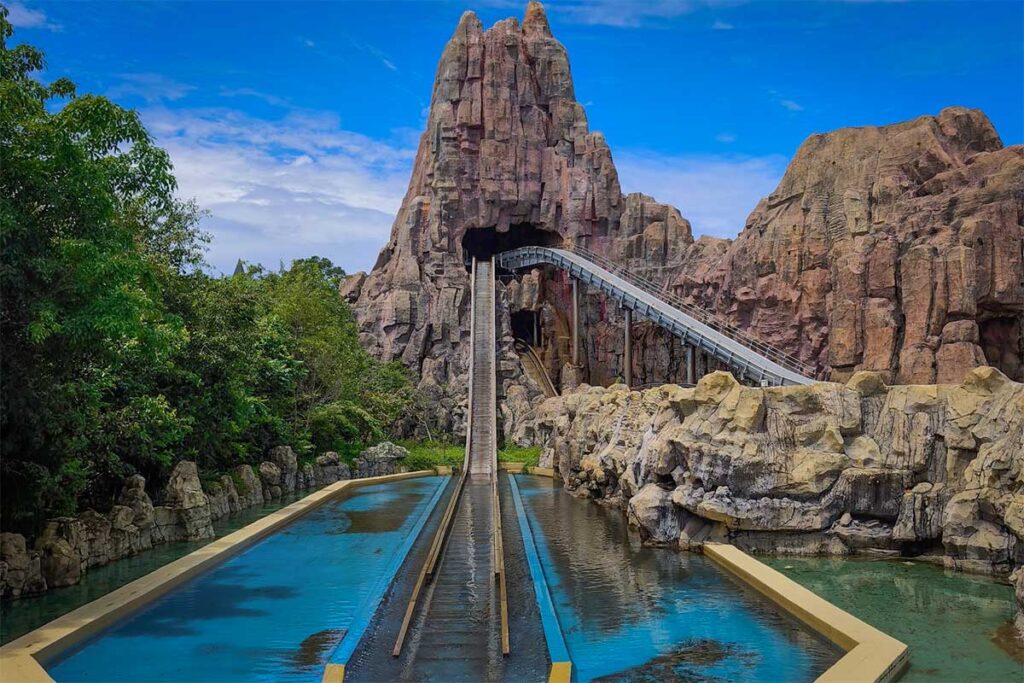 Mountain themed water ride attraction at VinWonders Phu Quoc with steep splash track and rocky scenery