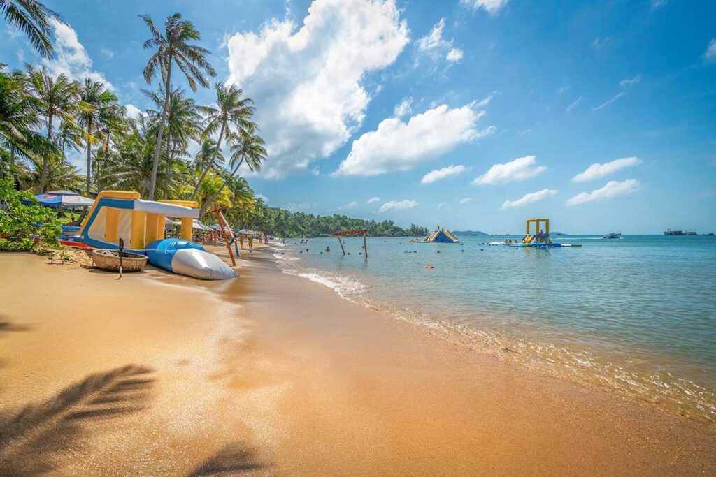 Water activities at Sun World Hon Thom beach with inflatable slides and clear shallow sea in Phu Quoc