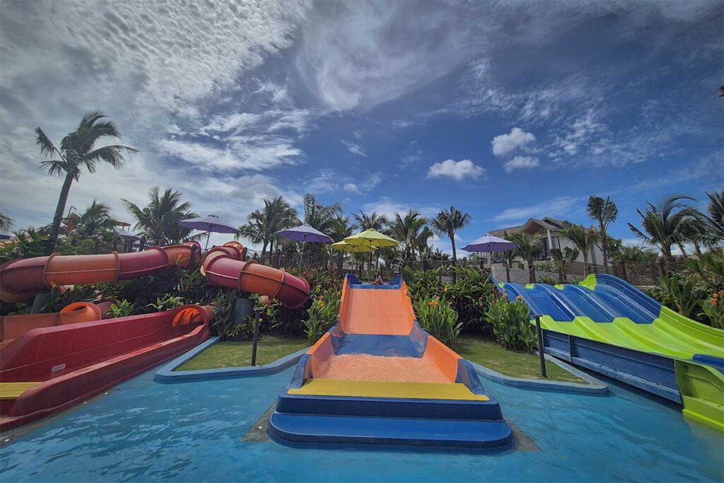 Colorful water slides and splash zone at New World Phu Quoc Resort family water park area near Khem Beach in Phu Quoc