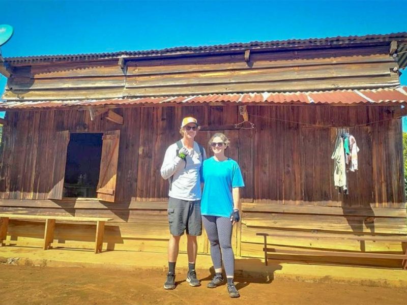 Cyclists visiting a local village house on a countryside cycling tour in Dalat, showing authentic rural life around Dalat