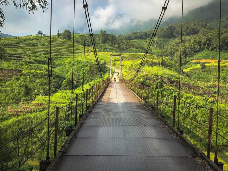 A steel bridge leading to Nam Dam Village