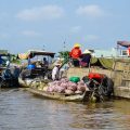 Vendors selling produce such as onions and cassava directly from boats at Cai Rang Floating Market in Can Tho.