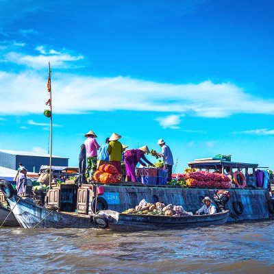 People selling goods from their boats at the Cai Rang Floating Market.