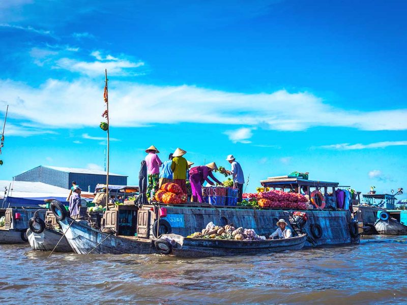 People selling goods from their boats at the Cai Rang Floating Market.