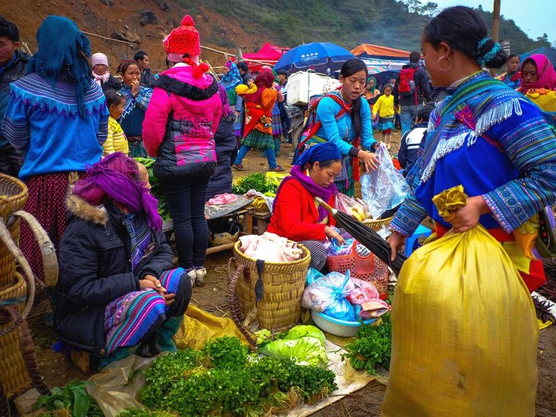 colorful minority woman shopping food at the Can Cau Market