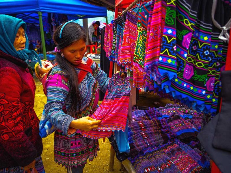 minority woman shopping clothes at Can Cau Market