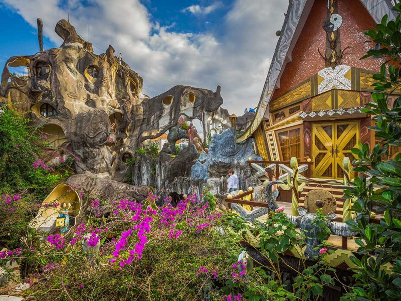 Fairytale-style buildings at Crazy House Dalat surrounded by gardens and imaginative design
