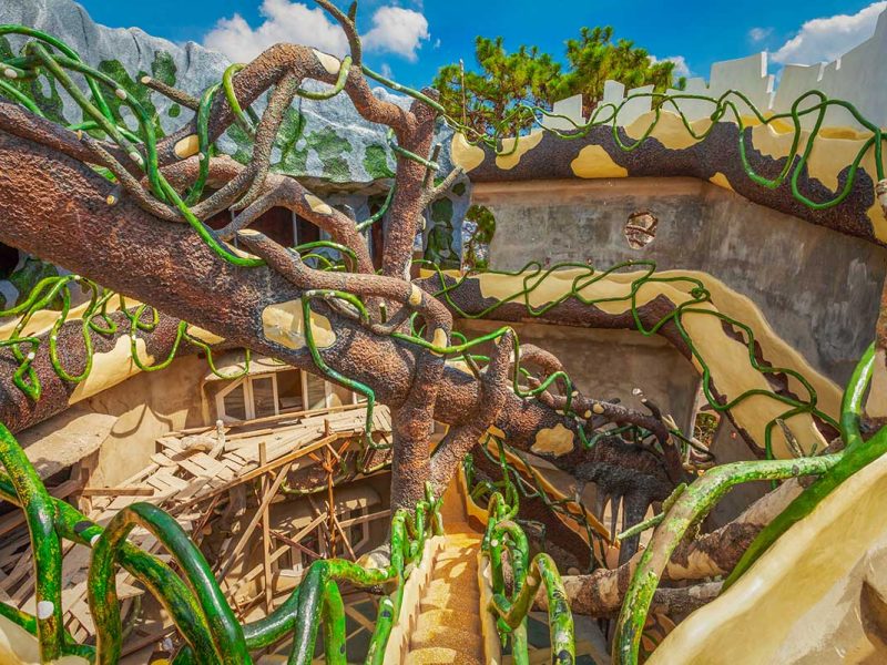 Twisting staircases with vine-like railings inside Crazy House Dalat, showcasing its surreal design