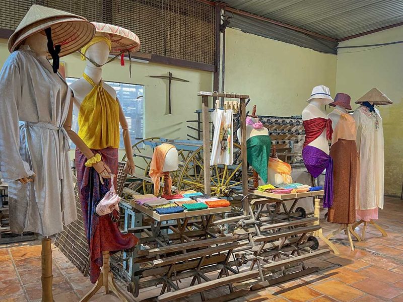 Display of finished silk clothes at Cuong’s Silk Factory in Dalat, showcasing locally produced Vietnamese silk garments