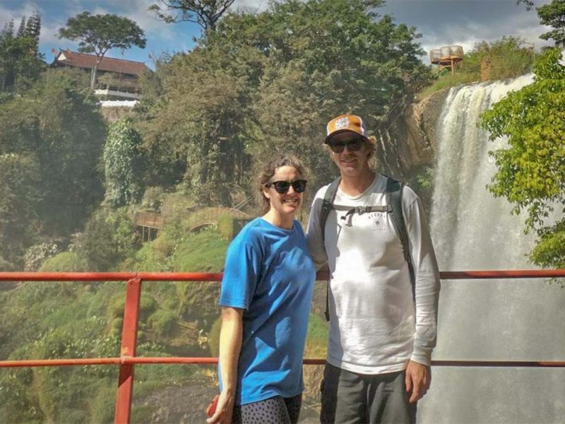 Cyclists visiting a waterfall near Dalat on a countryside cycling tour, combining nature and adventure around Dalat