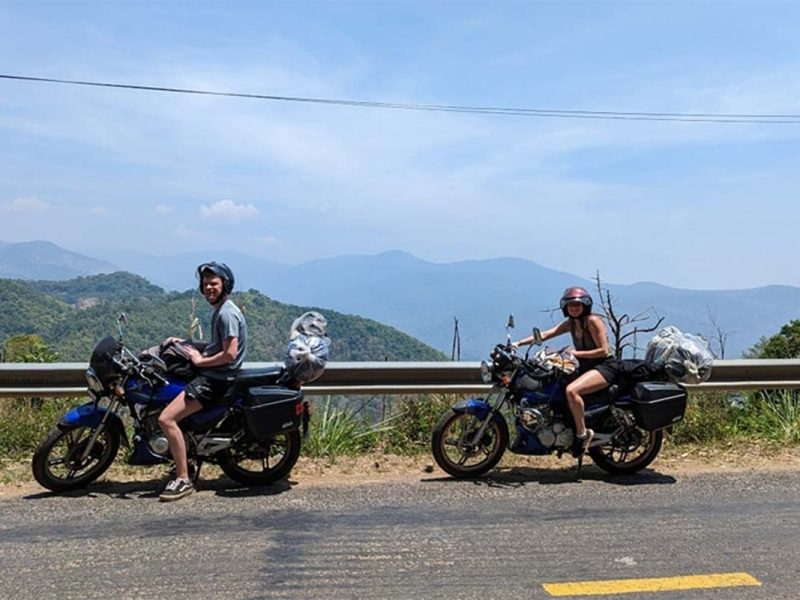 Tourists stopping by the roadside on a Dalat to Mui Ne Easy Rider tour, enjoying mountain views before descending toward the coast
