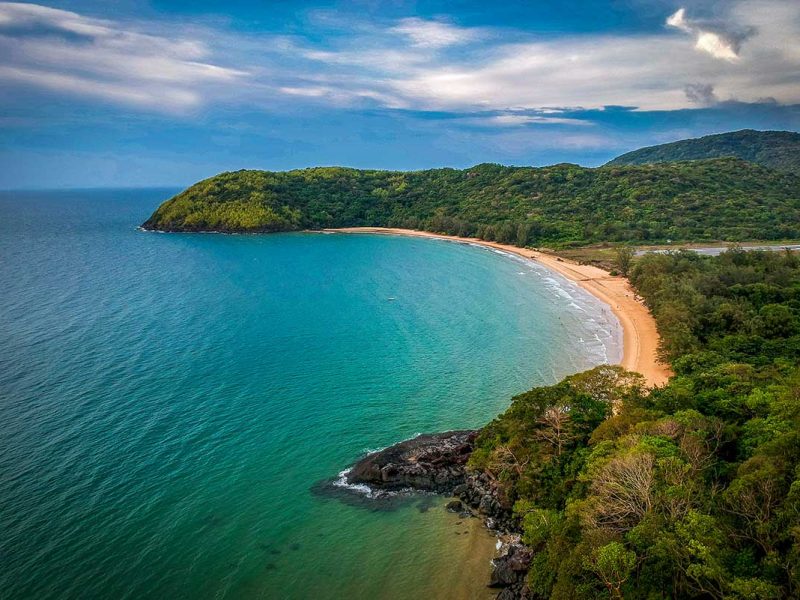 A breathtaking aerial view of Dam Trau Beach, with its crescent-shaped bay and untouched coastline, free of development.