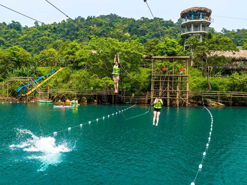 dark cave phong nha 1 Two people on a zipline dropping themself in the river below at the Dark Cave in Phong Nha