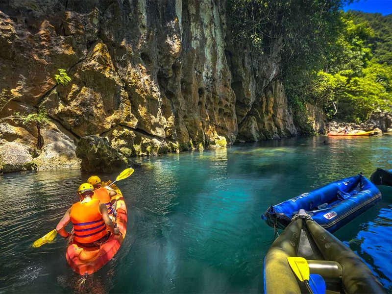 dark cave phong nha 7 Two travelers are kayaking on the river at entrance of Dark Cave in Phong Nha