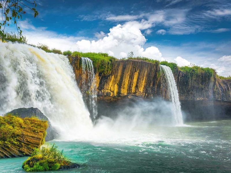 The breathtaking Dray Nur Waterfall, showcasing its immense power and misty spray as it plunges into the river.