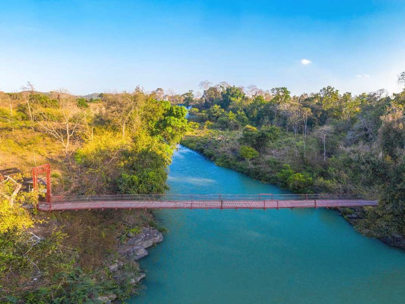 A scenic bridge crossing the river, linking the pathways between Dray Nur and Dray Sap Waterfalls.