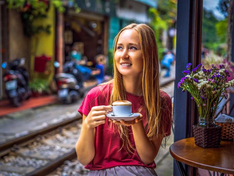 egg coffee hanoi train street 1 A woman drinking Vietnamese Egg Coffee in Hanoi Train Street