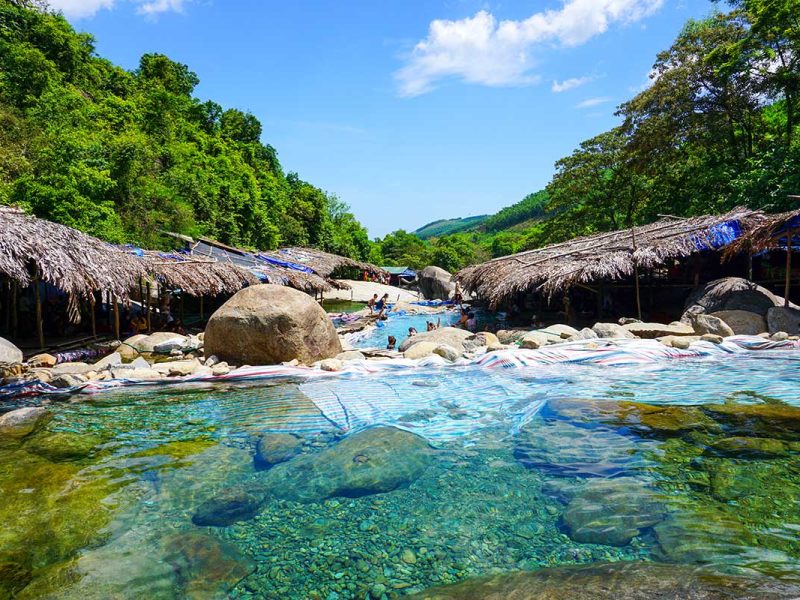 Series of mini waterfalls within jungle setting and small bamboo huts at the Elephant Spring in Hue