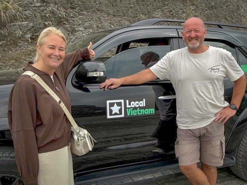 Local Vietnam guests on a Ha Giang Loop car tour, photographed during an actual stop along the route, highlighting our locally operated tours and real customer experiences in the mountains of Ha Giang.